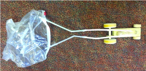 Photo of a toy car with a parachute attached to cause air resistance.
